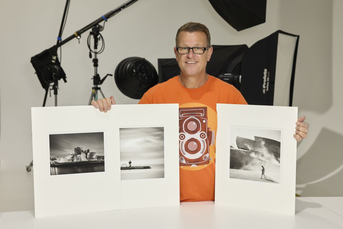 Portrait of Ian with final Black and White prints of award winning images.