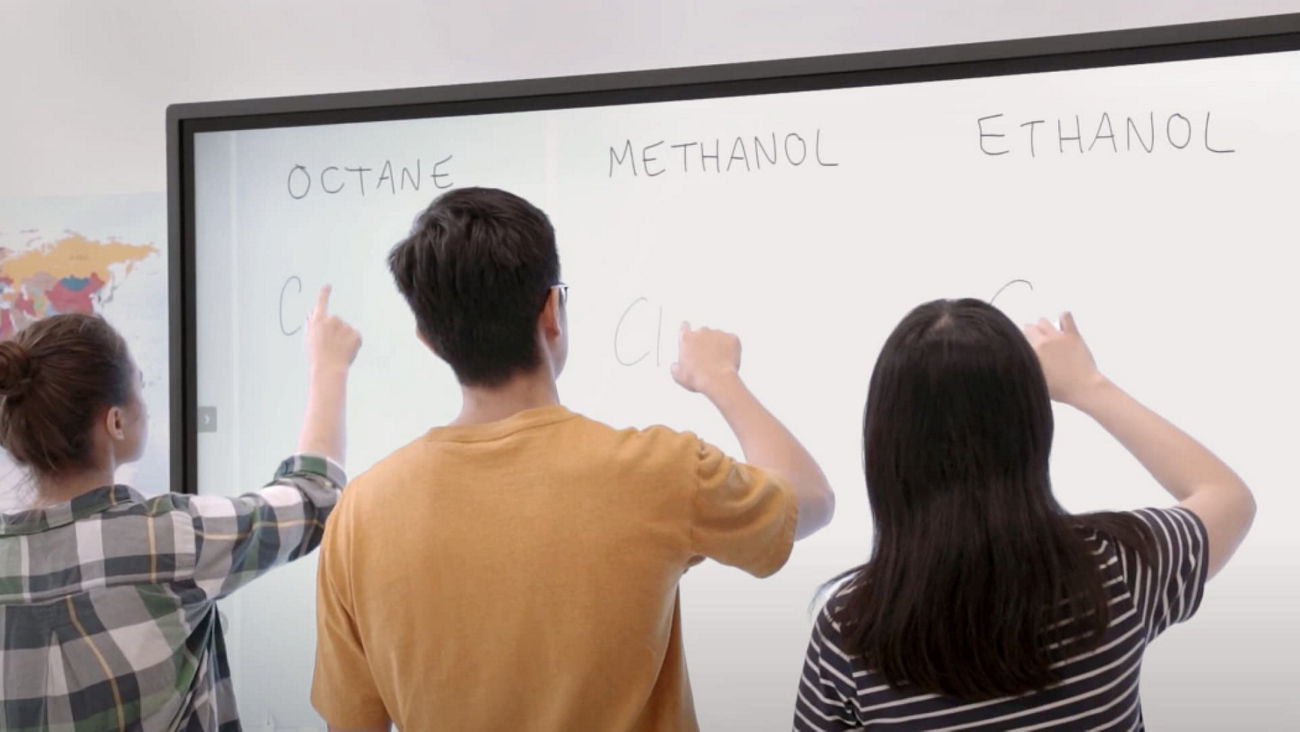 Students writing side-by-side on BenQ Board