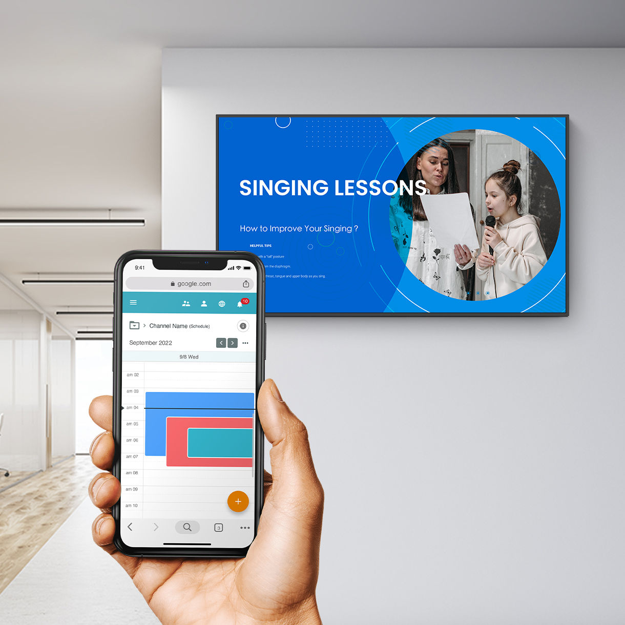 Smartphone showing content calendar and a digital signage display in a hallway