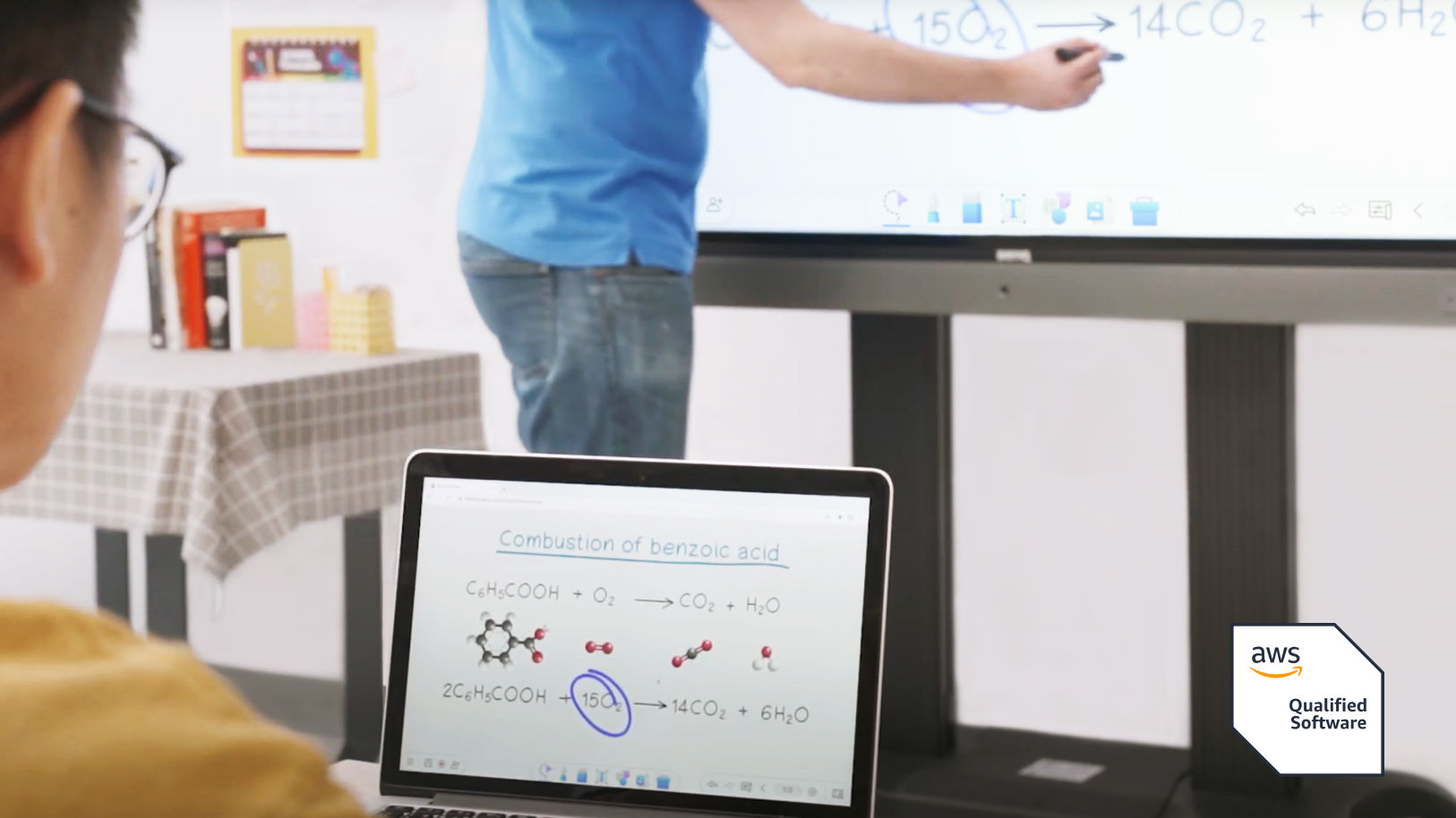 Student seeing whiteboard on laptop in realtime while teacher writes on the BenQ Board interactive display