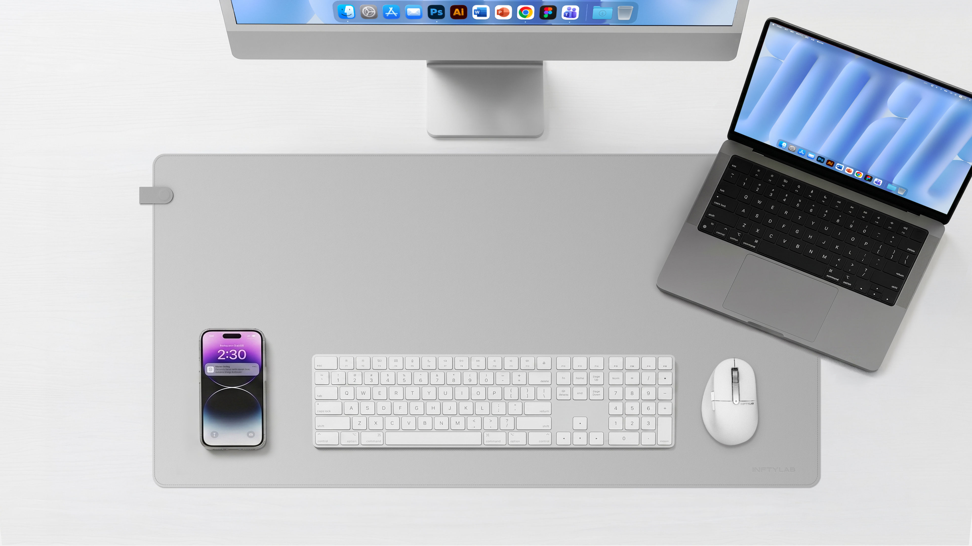 INFTYLAB FLOW Desk Mat for Mac, shown on a clean Mac desk setup with Studio Display and MacBook Pro