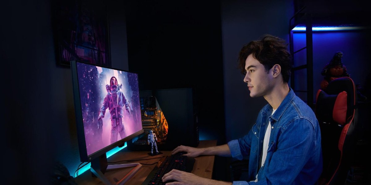 a man playing games on a 165hz gaming monitor