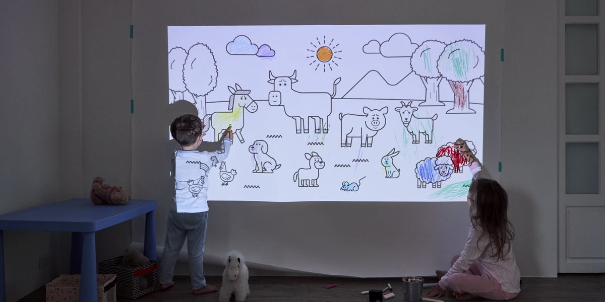 Kids drawing on a wal using a projector
