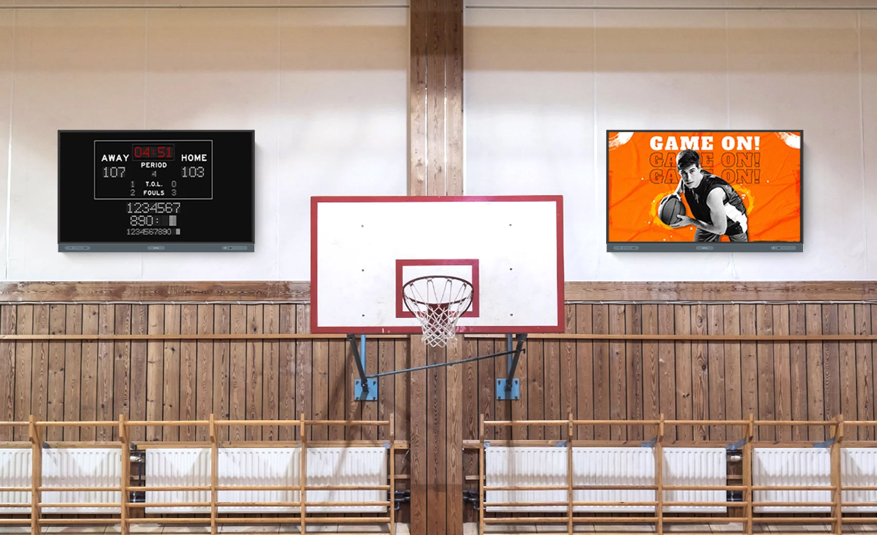 Basketball hoop in gym with two digital signage displays showing the game score