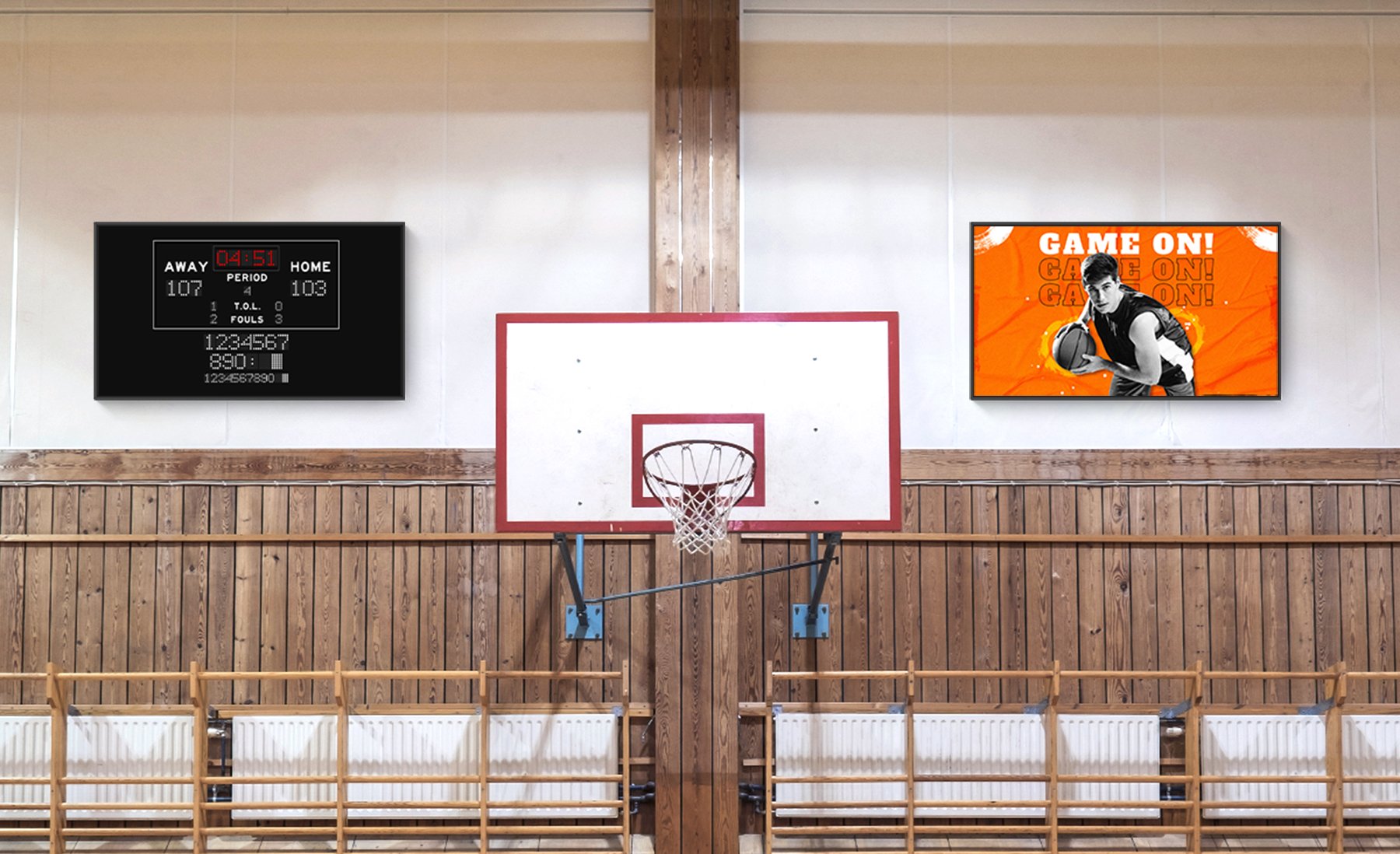 Basketball hoop in gym with two digital signage displays showing the game score
