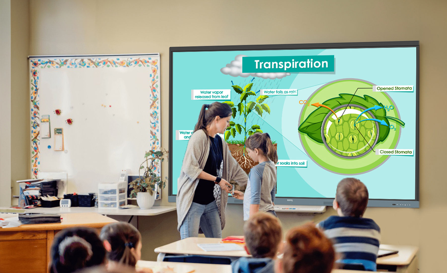 Teacher giving lesson in front of students with digital signage display showing timetable schedule