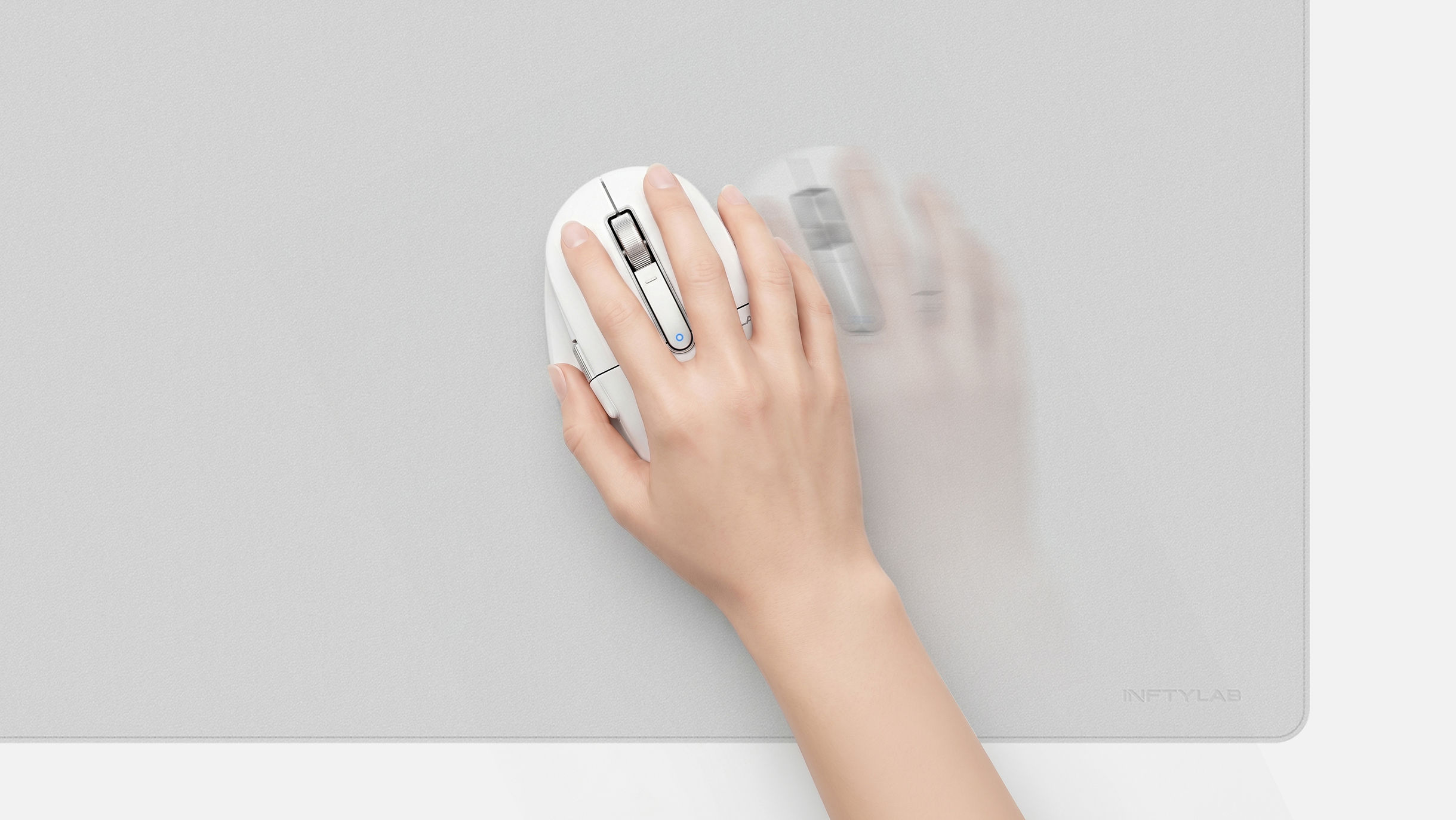 Hand gliding M Mouse across the FLOW Desk Mat surface, showing smooth low-resistance motion
