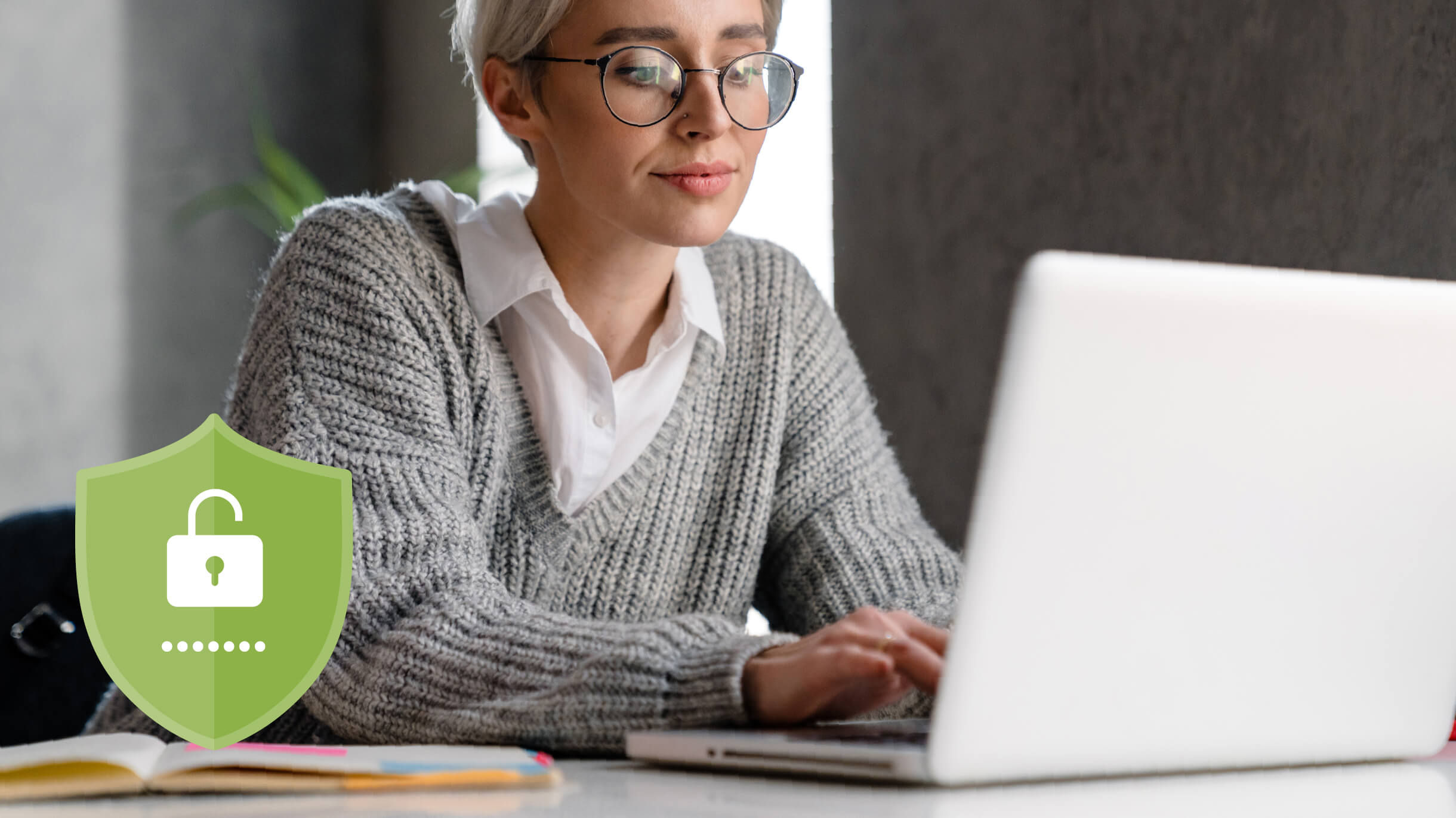 Lehrer, der einen Laptop mit einem Sicherheitssymbol benutzt