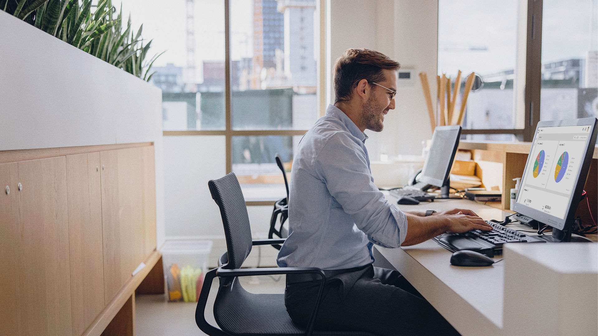 IT manager staff man typing on computer DMS management dashboard