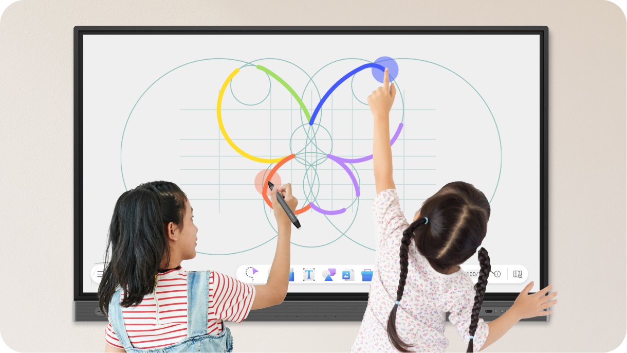 Two young students drawing and writing at the same time on the interactive whiteboard
