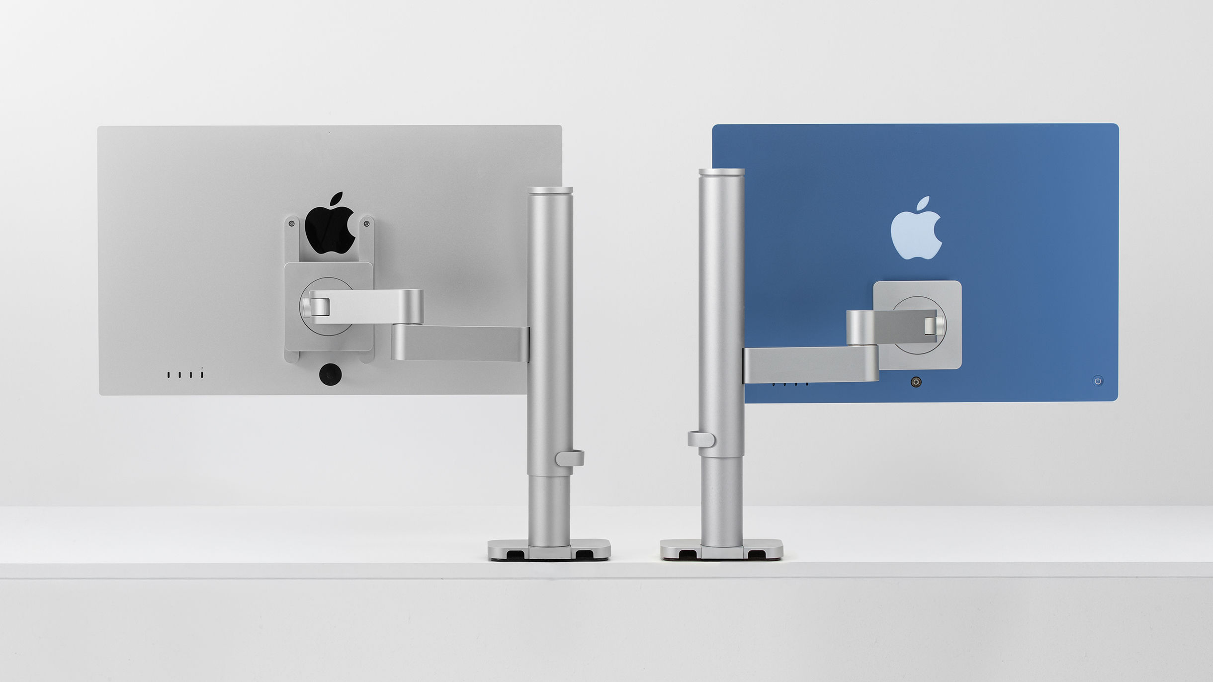 Apple Studio Display and iMac mounted on INFTYLAB Studio Arms to show support for different Apple displays.