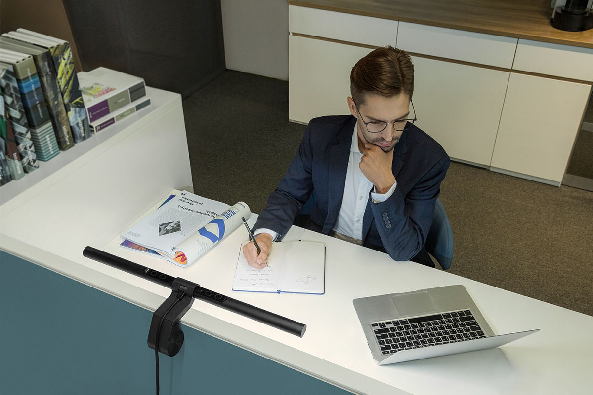 He is staring at his laptop with ScreenBar in the front.