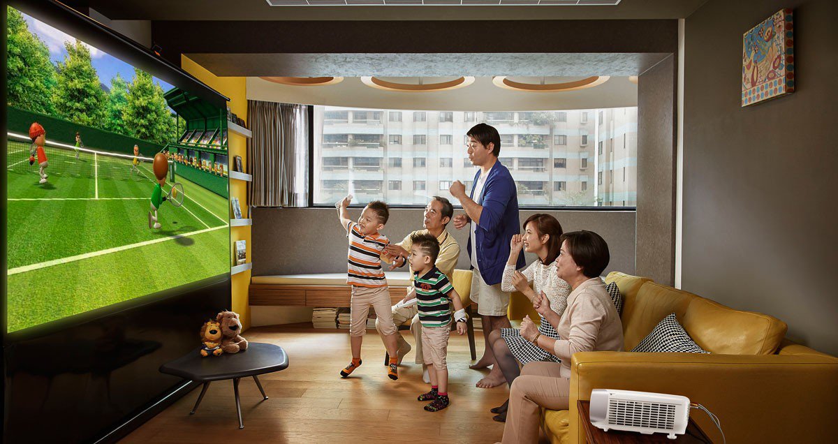 The family is enjoying the tennis video game with the big projection screen projected by BenQ home entertainment projector.
