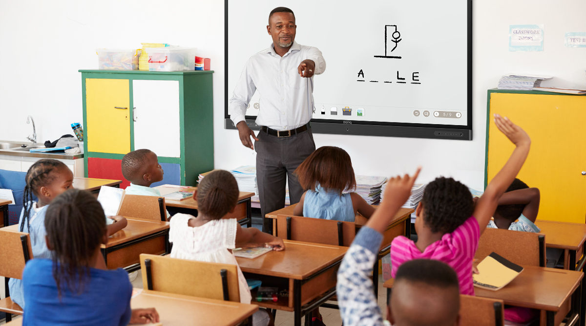 Teacher playing hangman with students in a classroom on Interactive Display