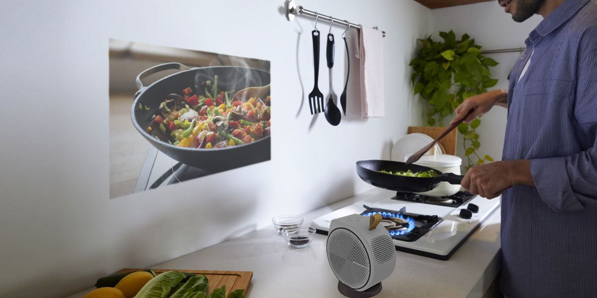 A man cooking using a projector