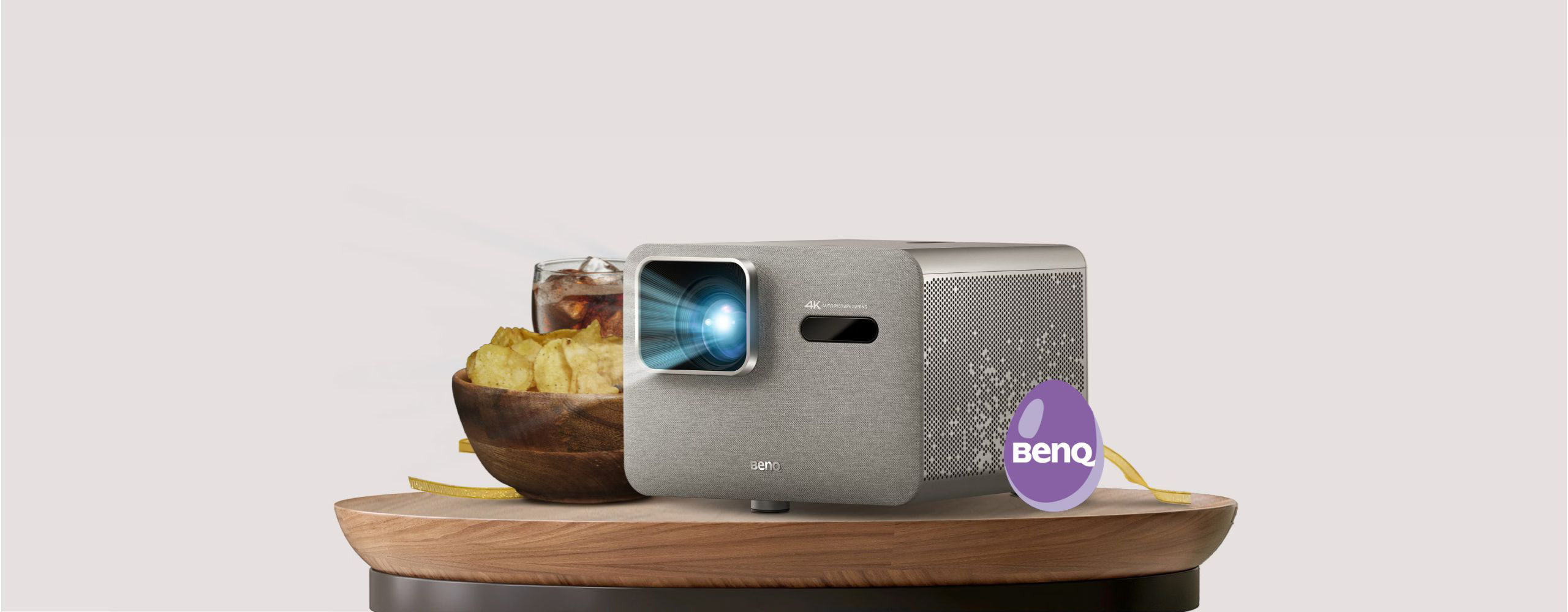 BenQ Home Entertainment Projector on a table with snacks and drinks, ready for a 4K party with zero setup hassle