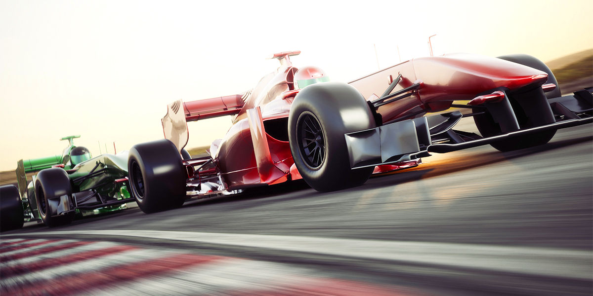 two F1 cars racing in high speed on the racing track