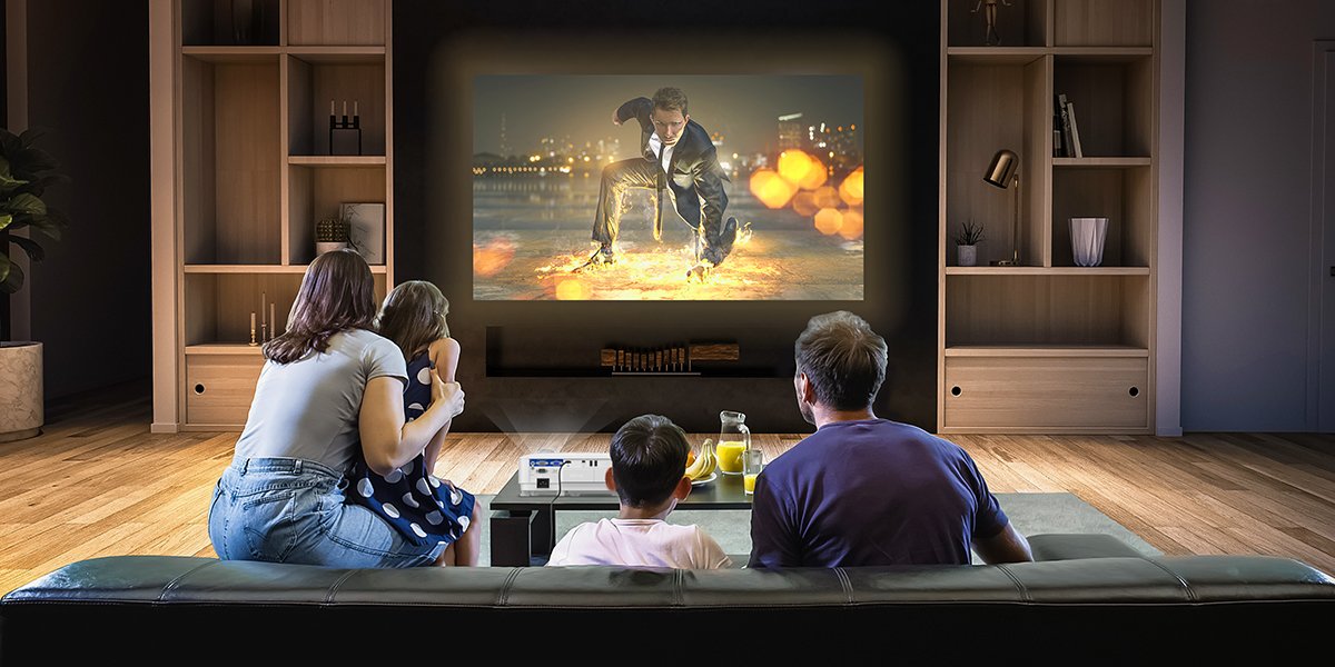a family of four watching movies in the living room on a smart projector