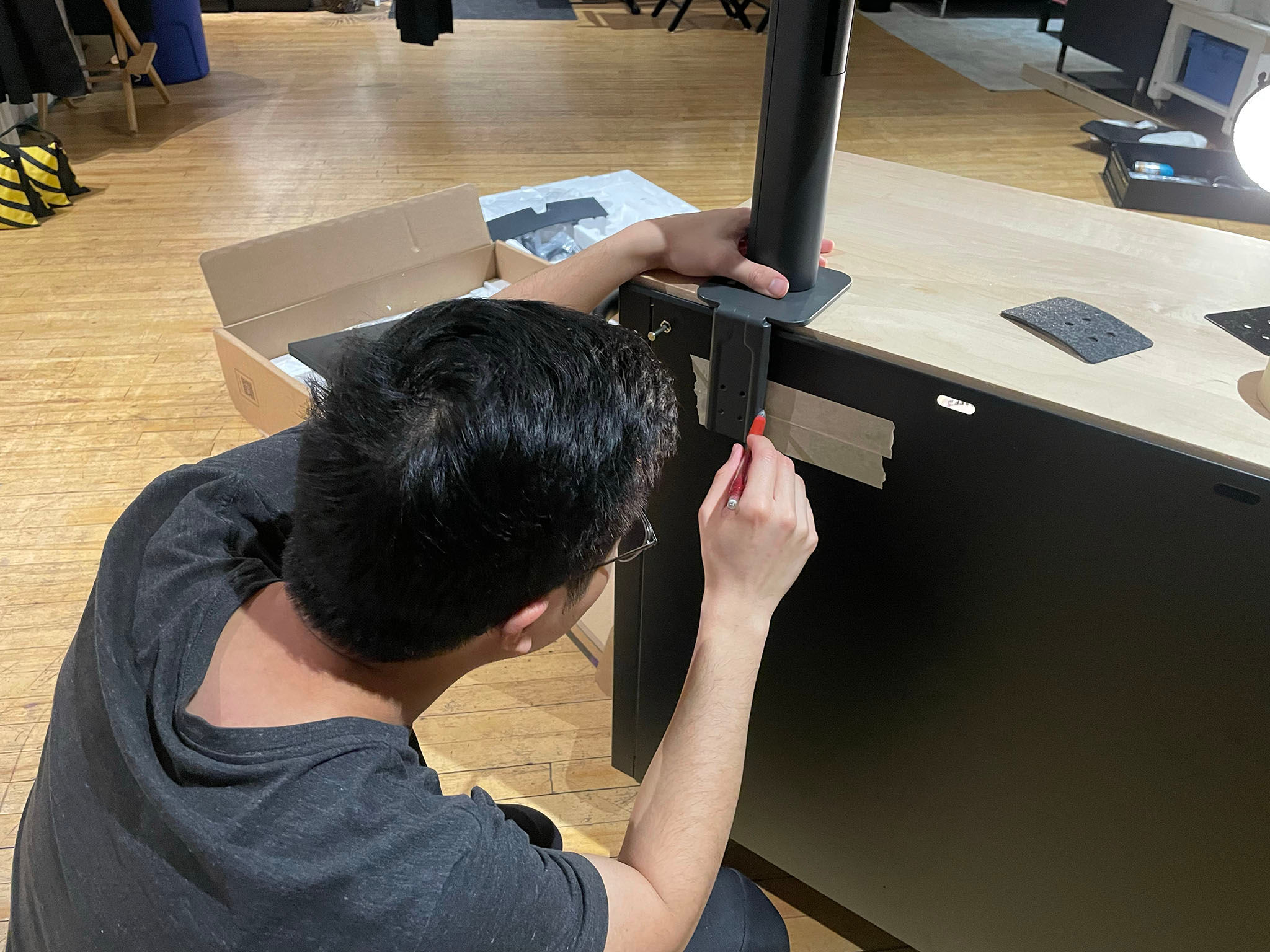 Martin (Giancarlo's assistant) drilled four holes to install the monitor arm.