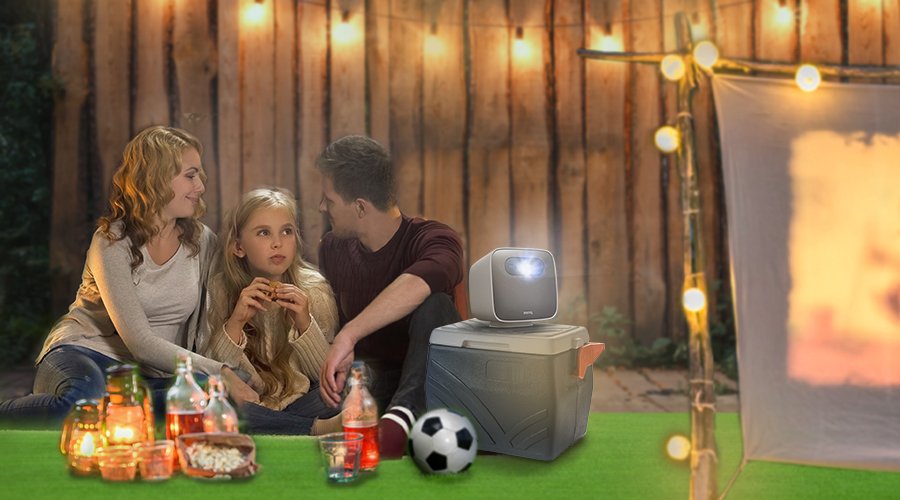 A family of three set up an outdoor cinema in the backyard on a portable projector GS2.