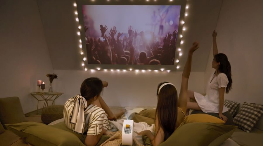 Young  girls watching movies on a slented wall using GV30 portable projector