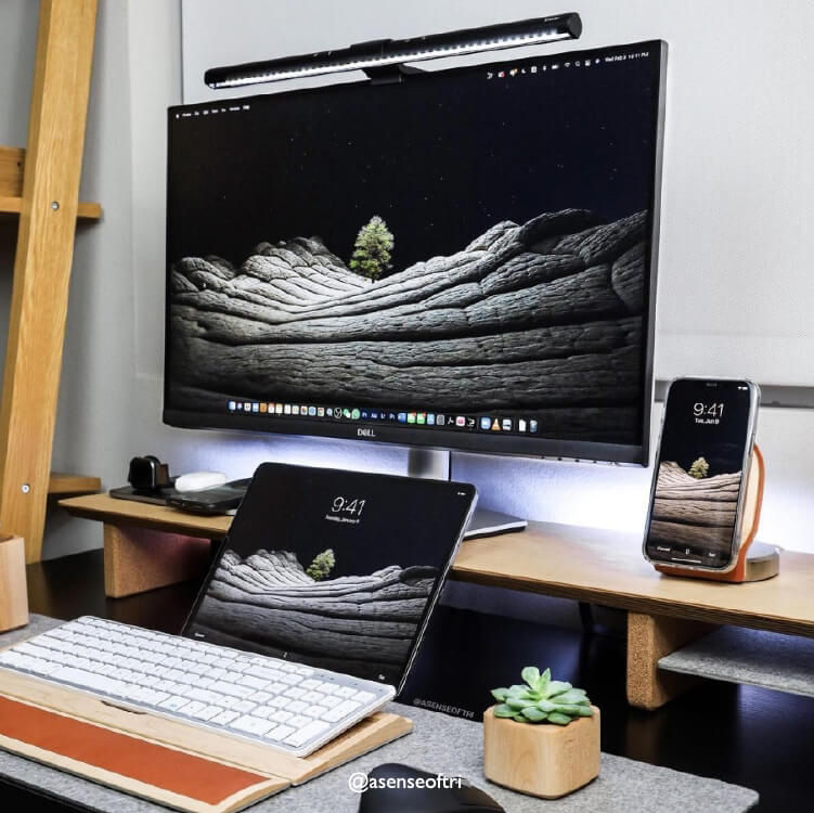 There is a desk setup with a ScreenBar on the monitor.