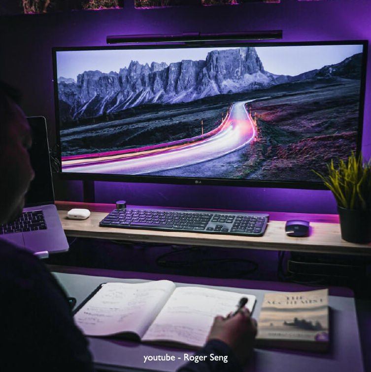 There is a desk setup with a ScreenBar on the monitor.