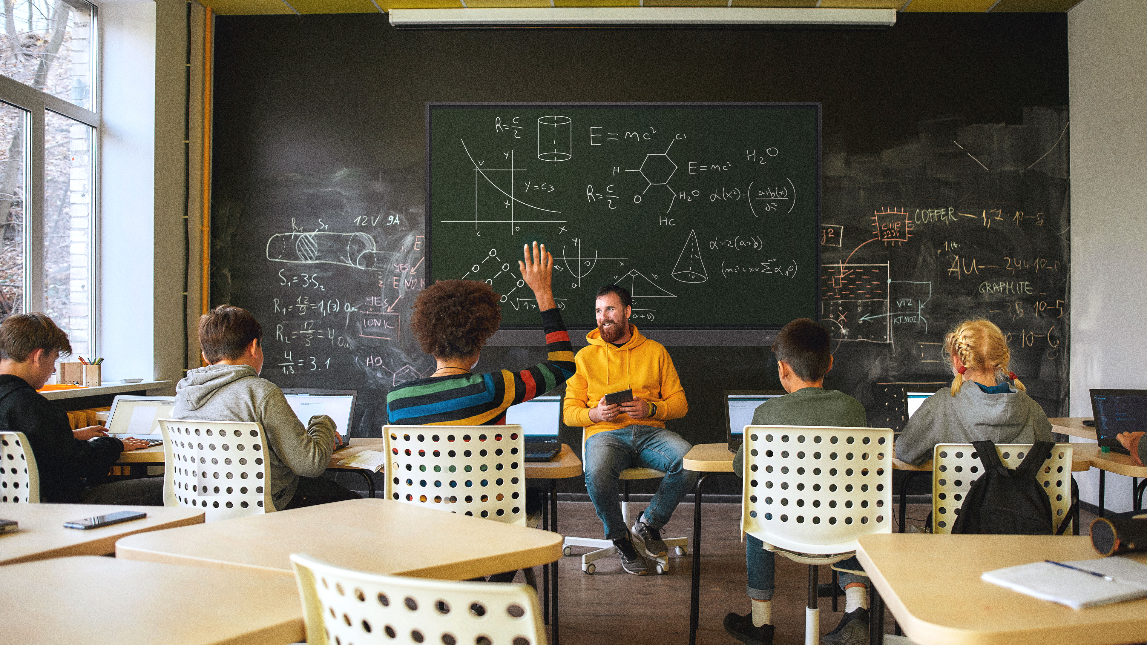 Teacher giving an engaging lesson to a group of students with an RP03 interactive display