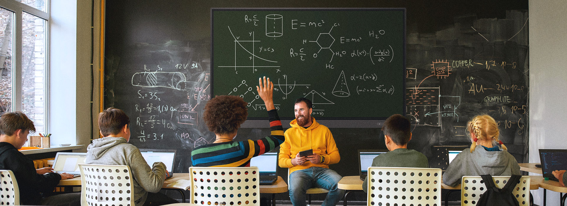 13.	Teacher giving an engaging lesson to a group of students with an RP03 interactive display