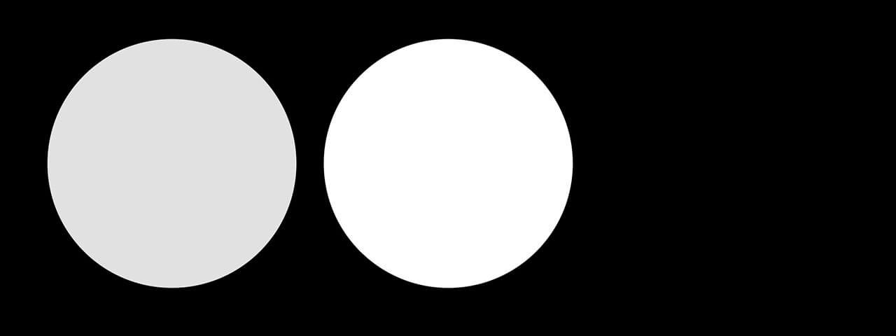 The black space contains two circles, one is grey and the other is white.