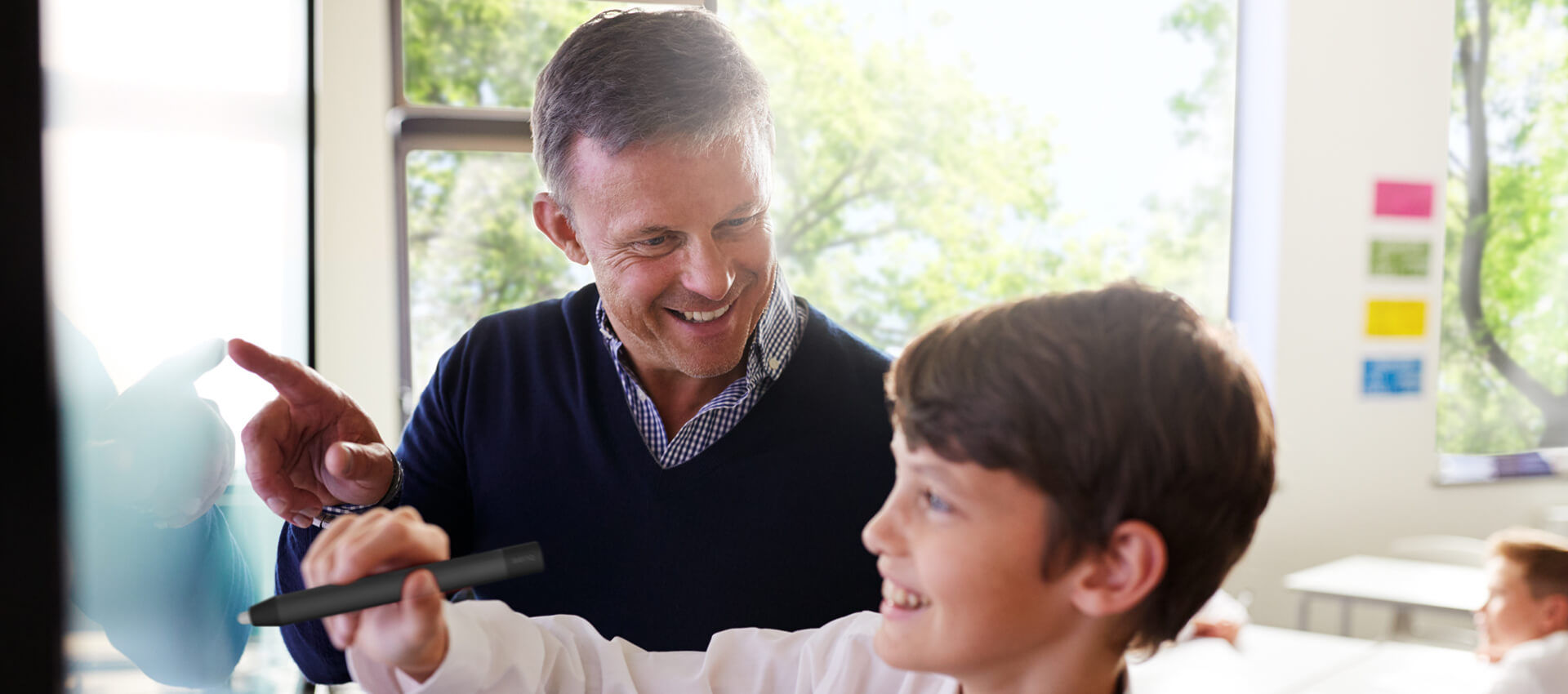 Engaged student enjoying the use of BenQ interactive flat panel in the classroom.