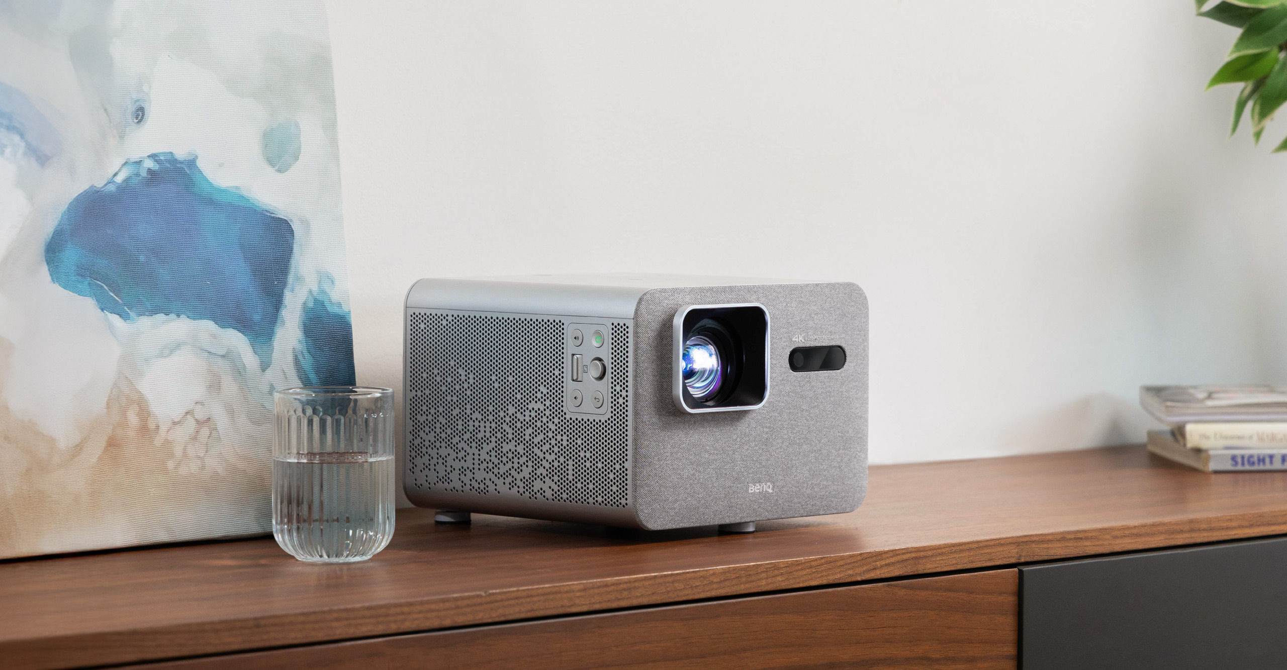 Friends enjoying a 150-inch 4K movie with a BenQ Home Entertainment Projector in a cozy living room watch party setting