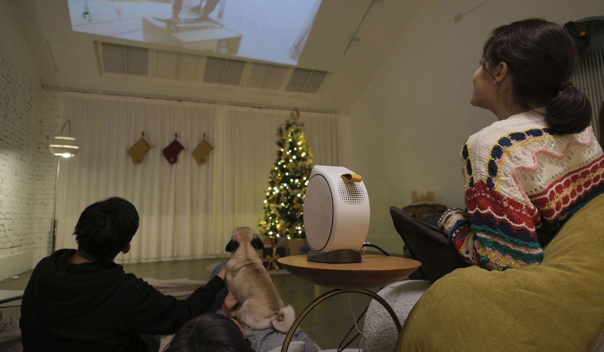 Family sharing memories on a big screen using portable projector