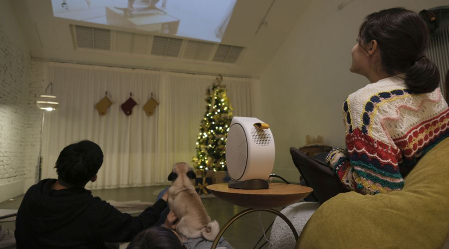 Family sharing memories on a big screen using portable projector