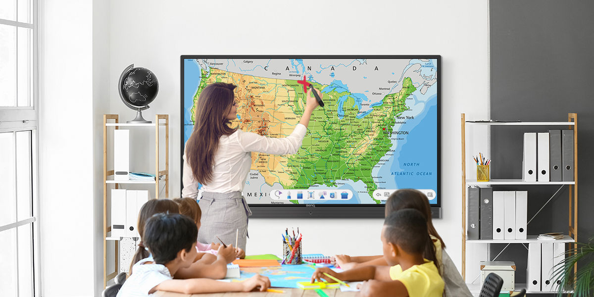 teacher using BenQ interactive display during geography class to mark on a map image via EZWrite digital whiteboard