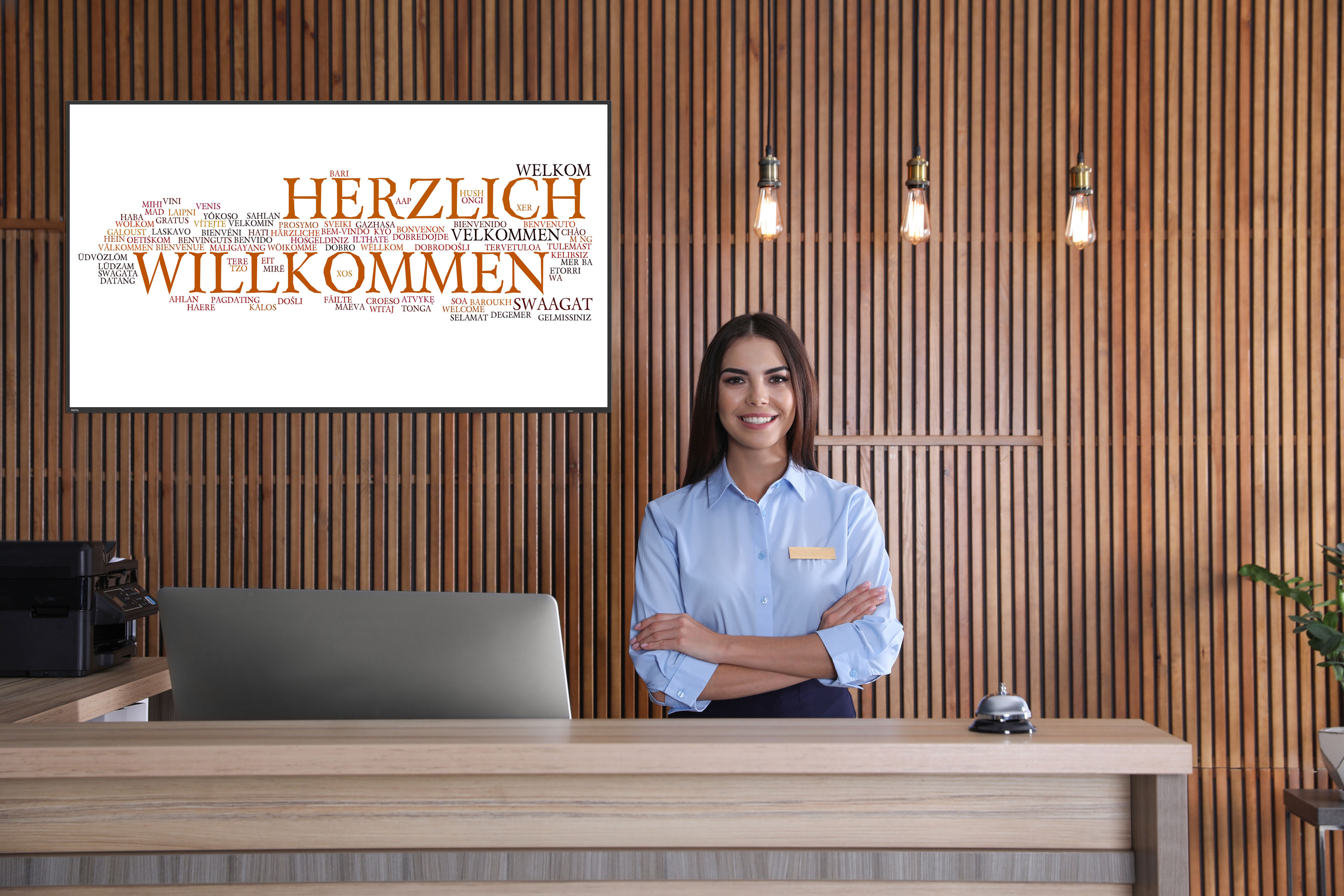 Portrait of receptionist at desk in lobby