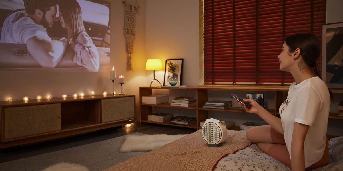 Young girl streaming content from her mobile phone on the big screen 