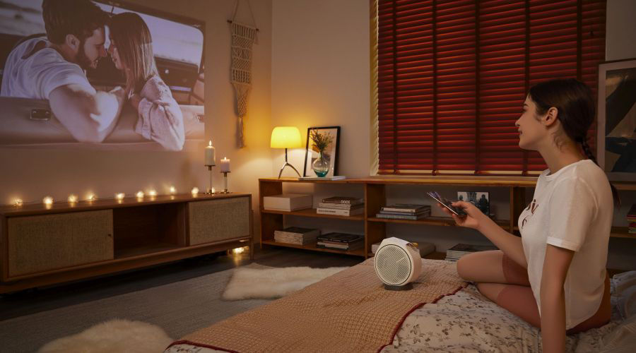 Young girl streaming content from her mobile phone on the big screen 