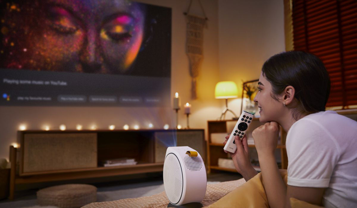 A young girl watching movies using a DLP portable projector