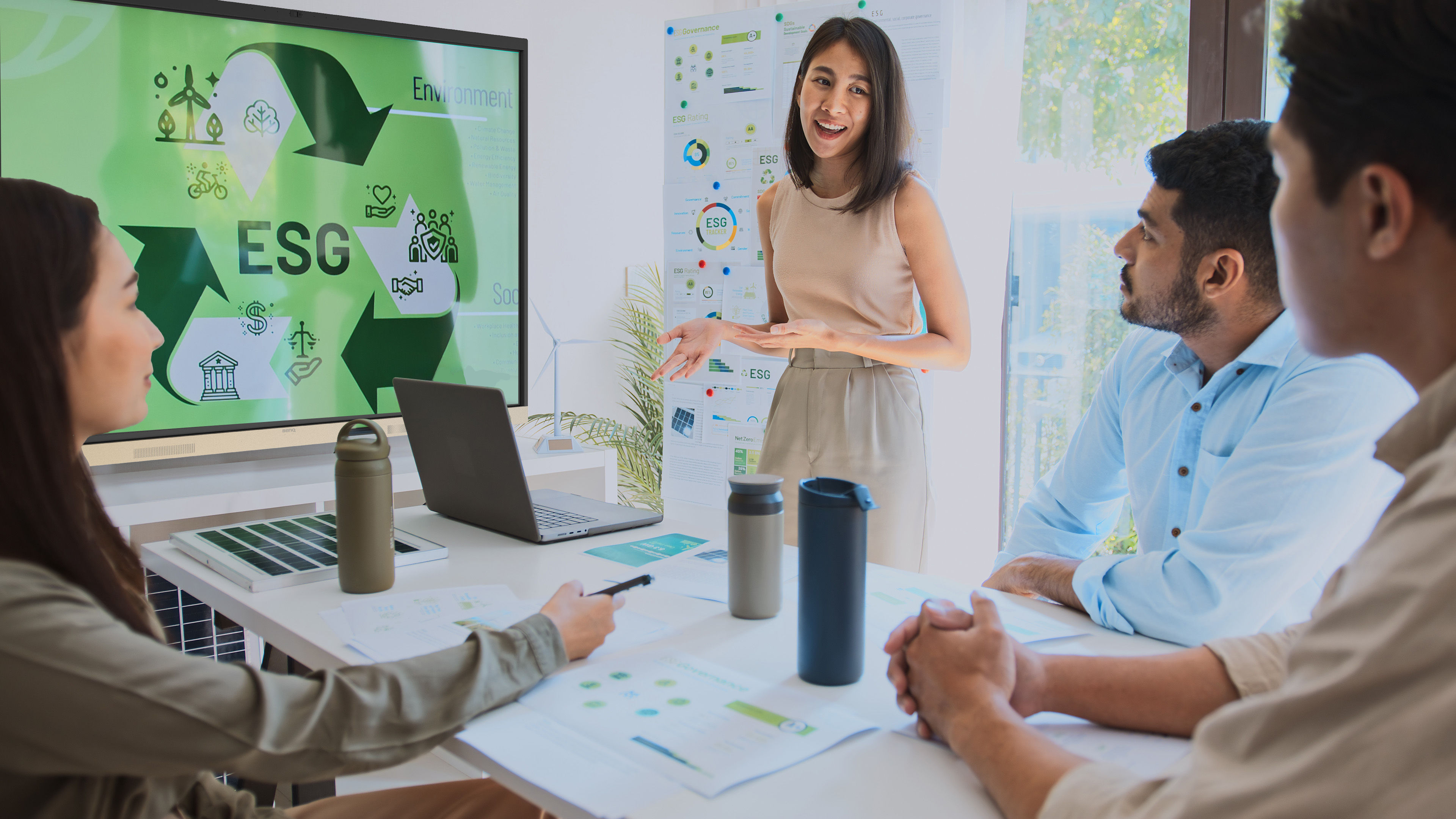 A sun-lit open layout office with a view of nature outside. The RE04FV is in the center of the room. Its wallpaper also shows nature.