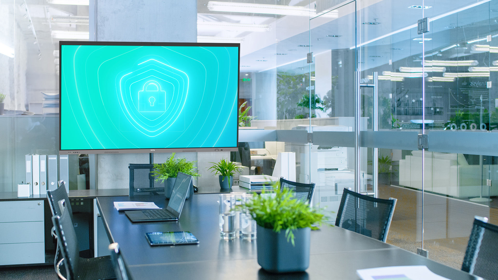 An image of the RE04FV2 with a lock on the screen. The setting is an office environment.