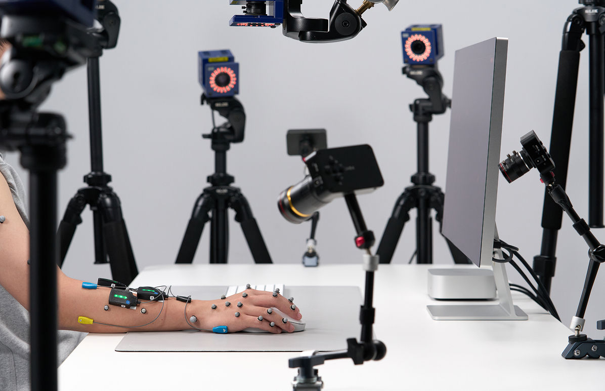 Motion capture system recording hand movement and posture for ergonomic research.