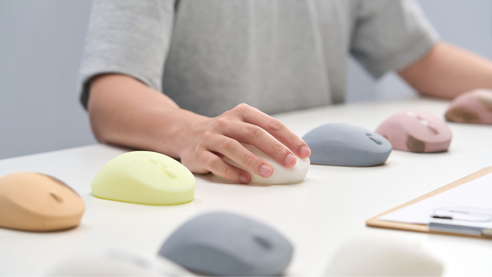 User testing different ergonomic mouse prototypes to explore hand posture, grip comfort, and support points.
