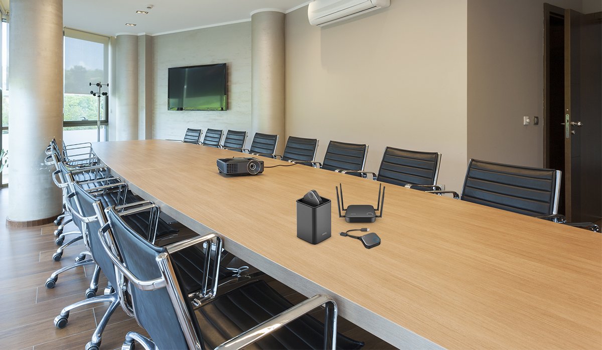 A conference room with BenQ InstaShow wireless presentation system on the table 