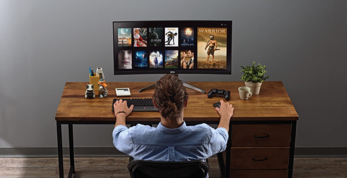 Man enjoys watching streaming and movies via BenQ Video Enjoyment Montior