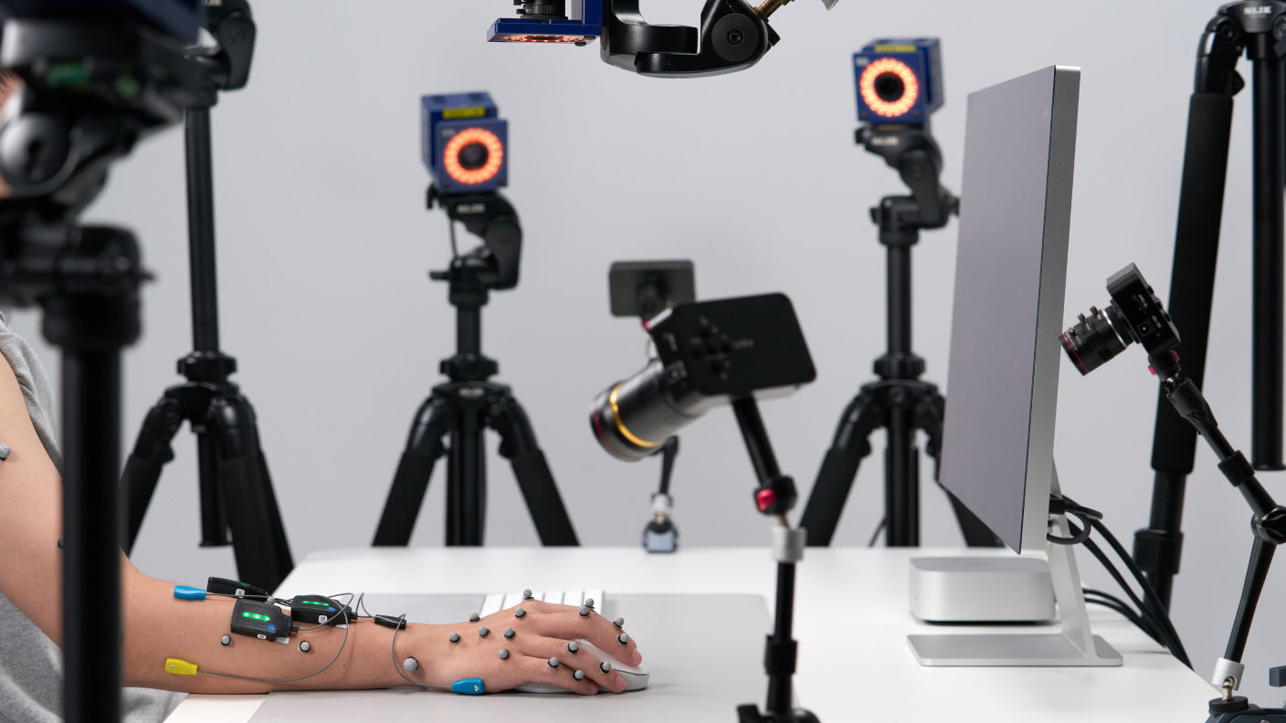 Motion capture system recording hand posture and mouse movements during ergonomic mouse research.