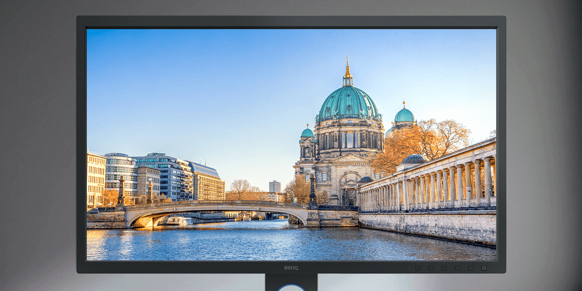 There is a matte monitor screen that shows a European cathedral church by a river.