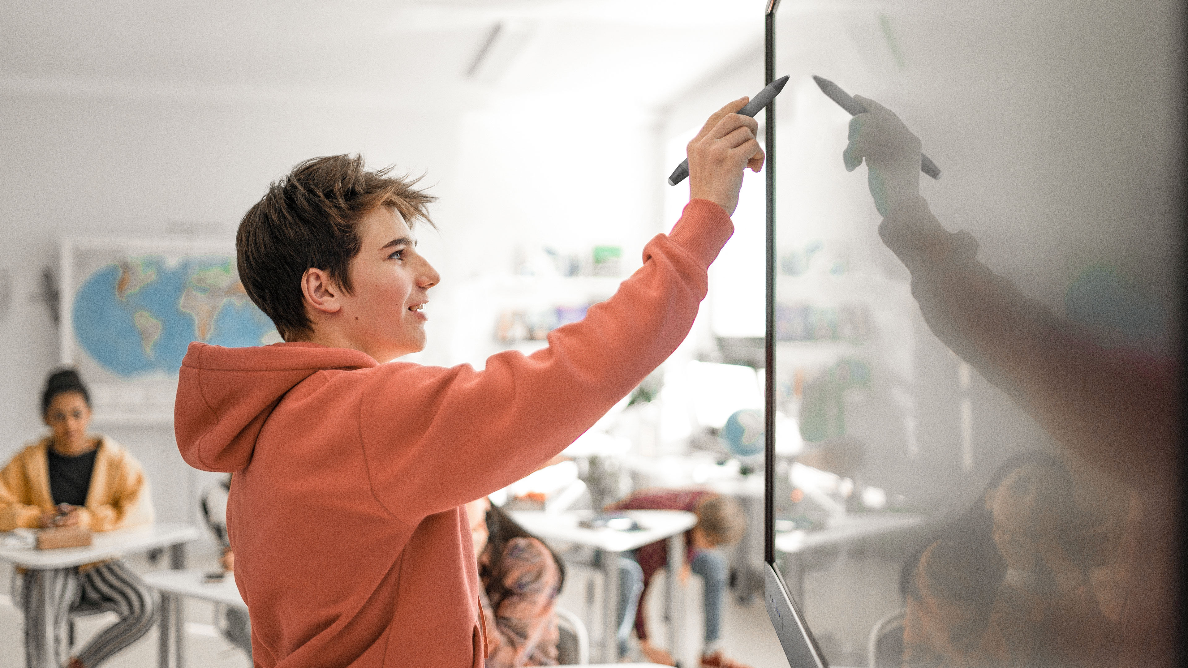 Two students smiling while working together on BenQ Board