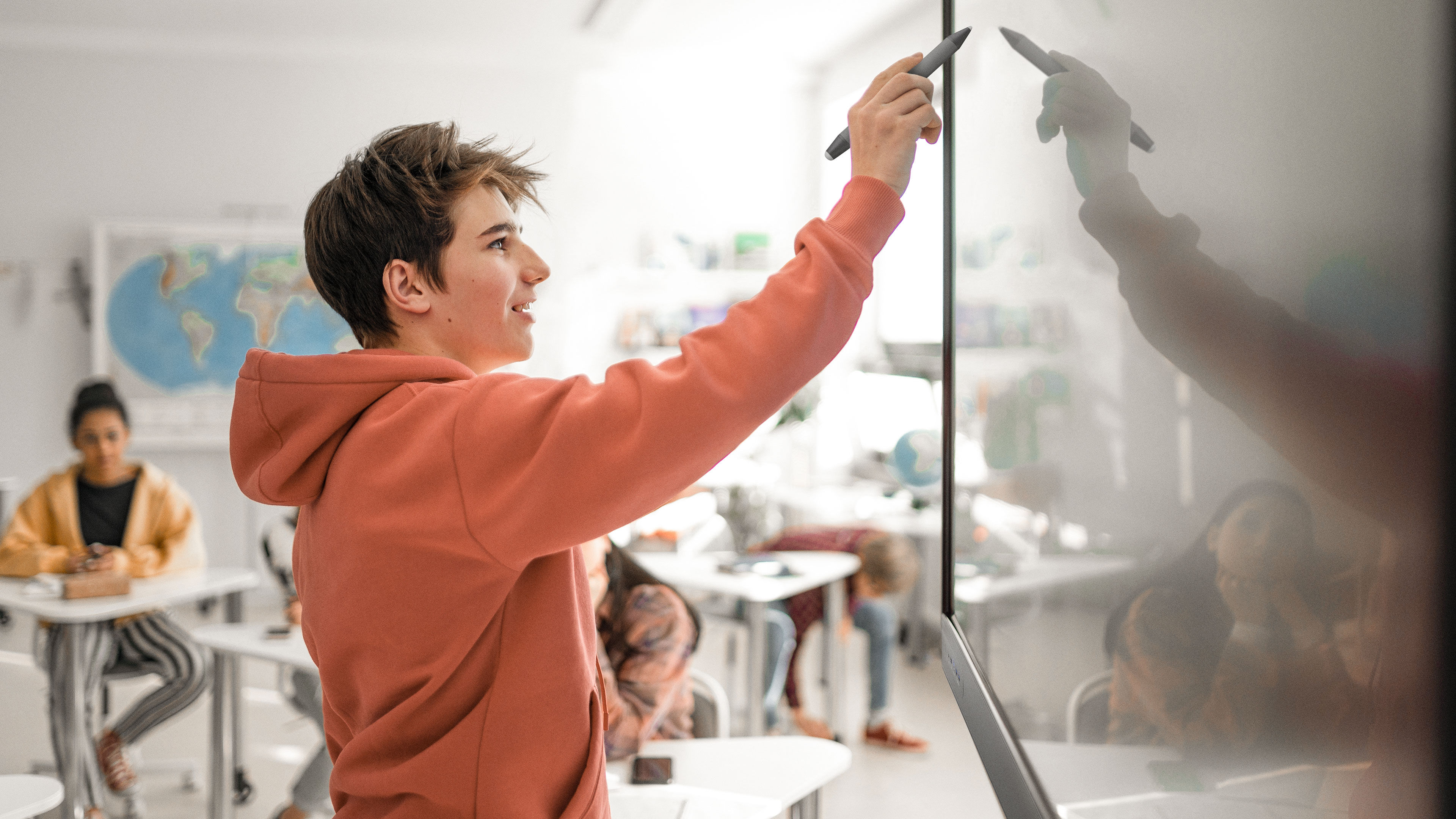 Two students smiling while working together on BenQ Board