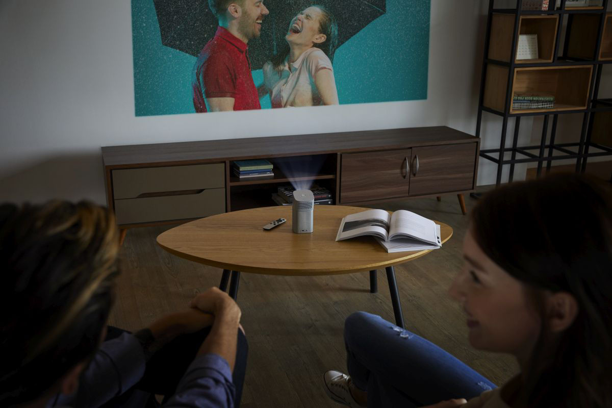 Portable projector on a table in a living room